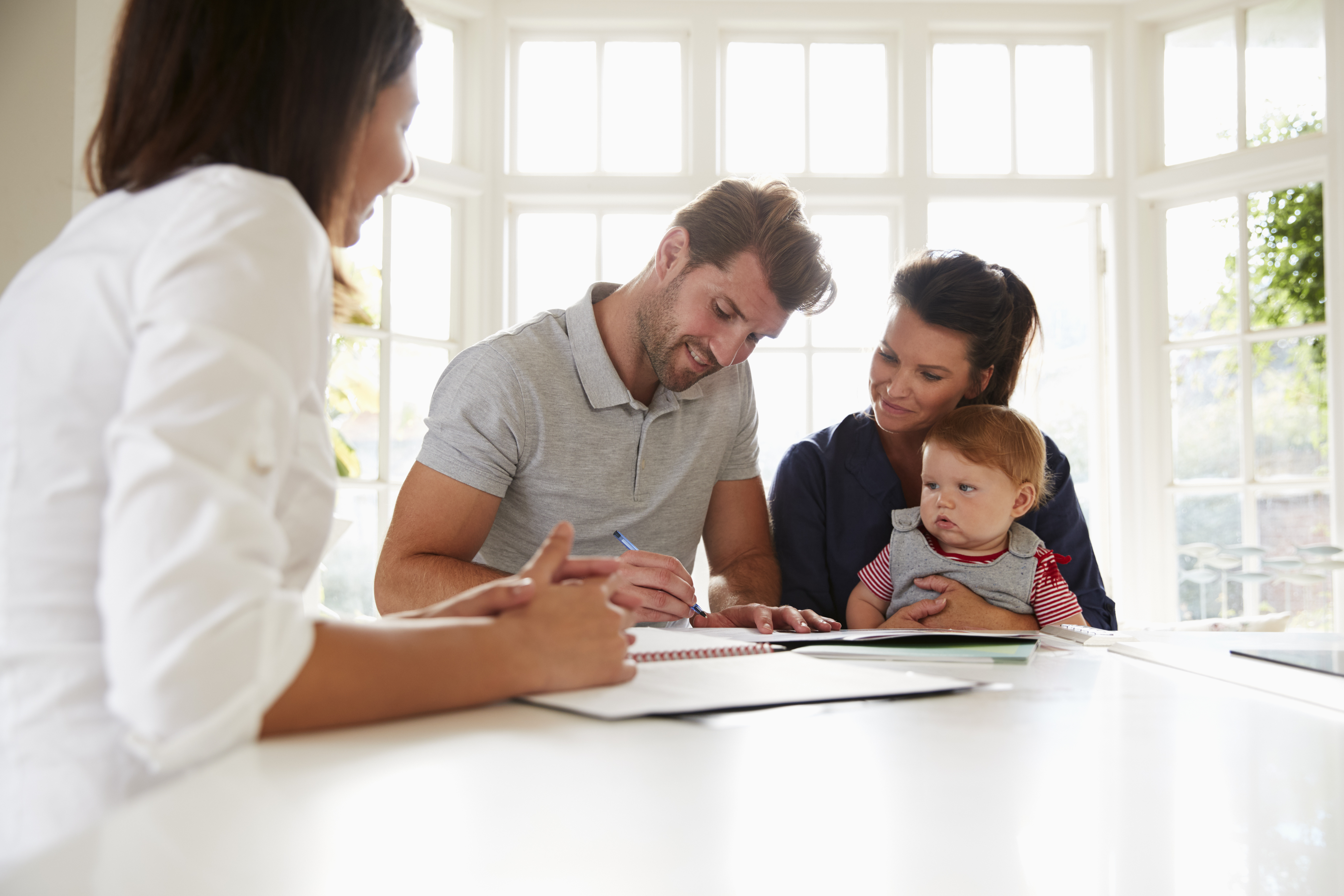 Family With Baby Meeting Financial Advisor At Home Ruhl Ruhl Realtors